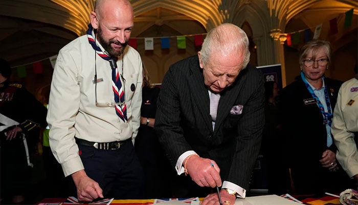 King Charles drew an outline of his hand for volunteering charities at Windsor Castle.