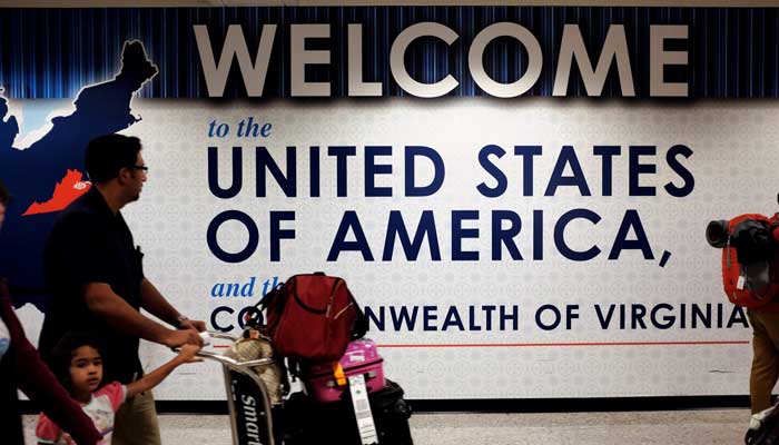 A family exits after clearing immigration and customs at Dulles International Airport in Dulles, Virginia, US. September 24, 2017. — Reuters