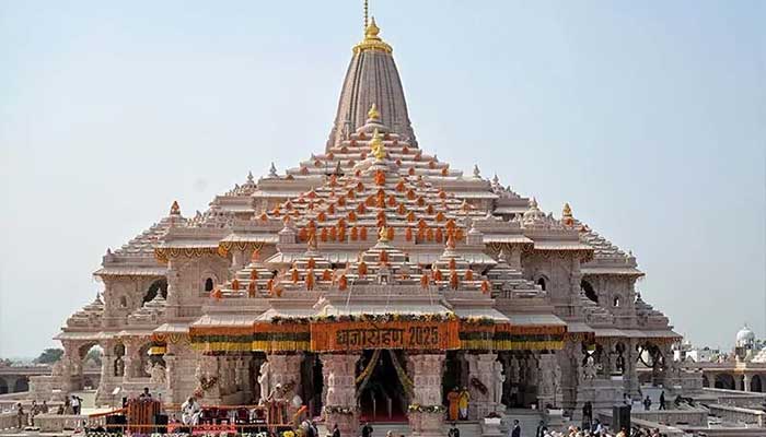 This handout photograph, taken and released by the Indian Press Information Bureau on November 25, shows Indian Prime Minister Narendra Modi (C) participating in a flag-hoisting ceremony to mark the completion of the Ram temples construction in Ayodhya, India. — Reuters