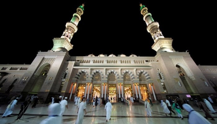 People make their way into Masjid Al-Nabawi for morning prayers in Madina, Saudi Arabia, May 20, 2018. — Reuters