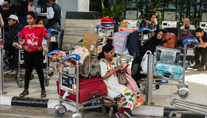 Passengers wait outside the IndiGo airlines ticketing counter at the Chhatrapati Shivaji Maharaj International Airport, after several IndiGo airlines flights were cancelled, in Mumbai, India, December 6, 2025. — Reuters
