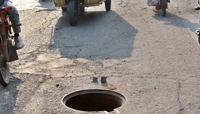 A representational image of an uncovered manhole. — APP/File