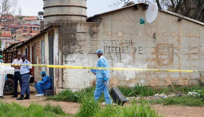 A police forensics member arrives at the scene where several people, including three minors, were killed in a mass shooting in Saulsville Hostel in Atteridgeville in Pretoria, South Africa, December 6, 2025.— Reuters