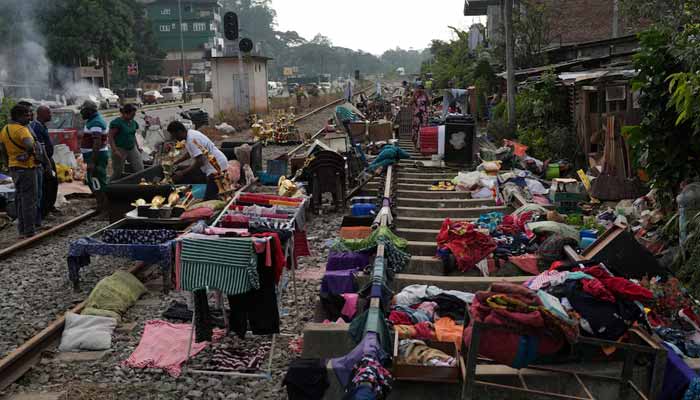 People affected by floods collect their belongings from the railway tracks after drying them following Cyclone Ditwah, in Kandy, Sri Lanka, December 3, 2025. — Reuters