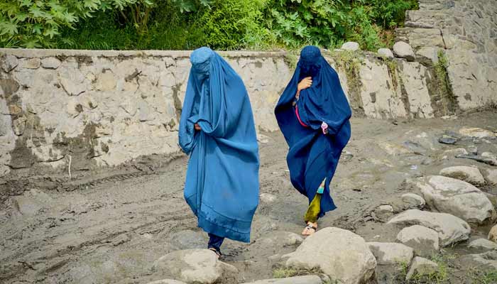 Afghan women in burqas walk towards a safer place after their house was damaged following a deadly magnitude 6 earthquake that struck Afghanistan.— Reuters