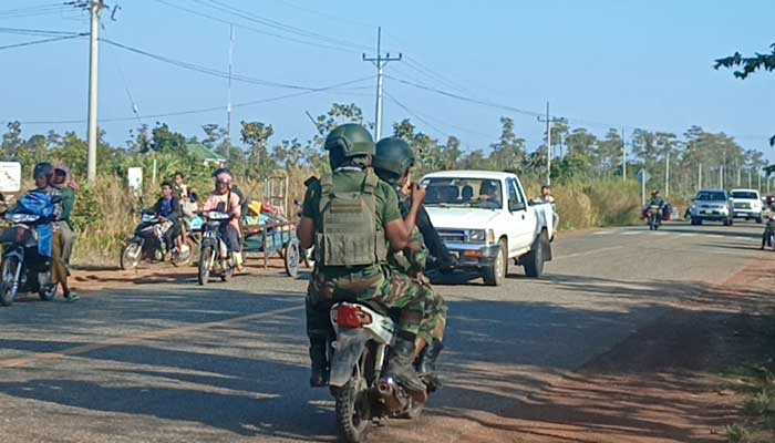 Cambodian soldiers ride their motorbike as local residents evacuate following clashes along the Cambodia-Thailand border in Preah Vihear province on December 8, 2025. — AFP