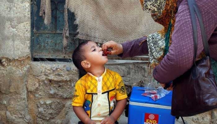 A boy receives polio vaccine drops, during an anti-polio campaign, in a low-income neighborhood in Karachi. — Reuters/File