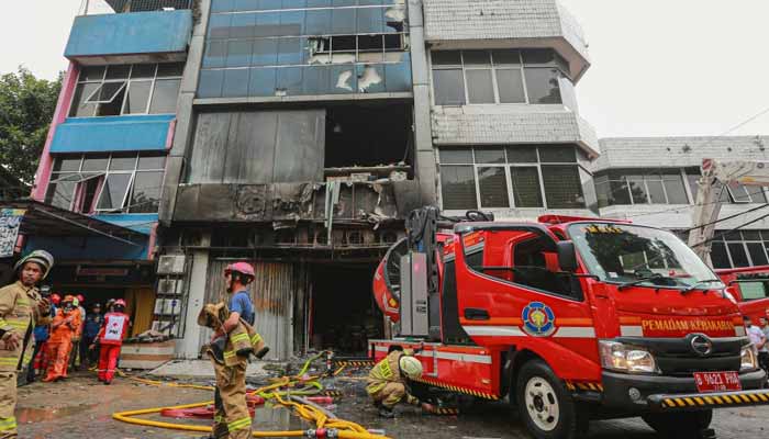 Firefighters are seen at the scene where they have extinguished a fire that killed at least 20 people at a seven-storey building in central Jakarta on December 9, 2025. — Reuters