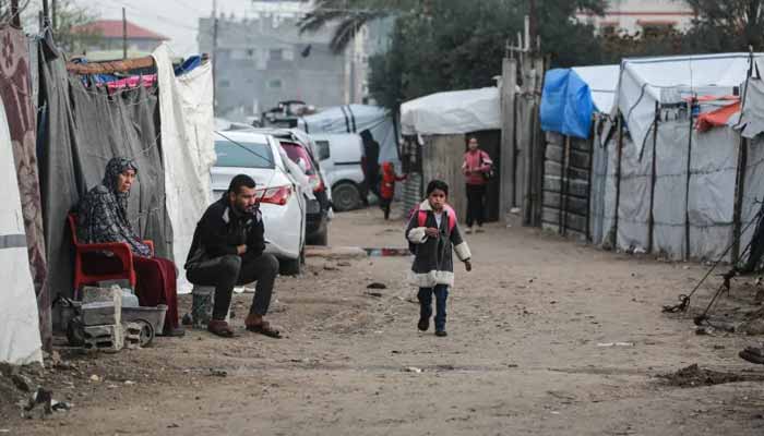 Palestinian child returns to school in Deir el-Balah, in the central Gaza Strip, on December 10, 2025. — AFP