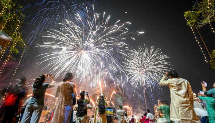 Local residents watch fireworks light up the sky as part of Diwali celebrations, the Hindu festival of lights, in Mumbai on October 22, 2025. — AFP