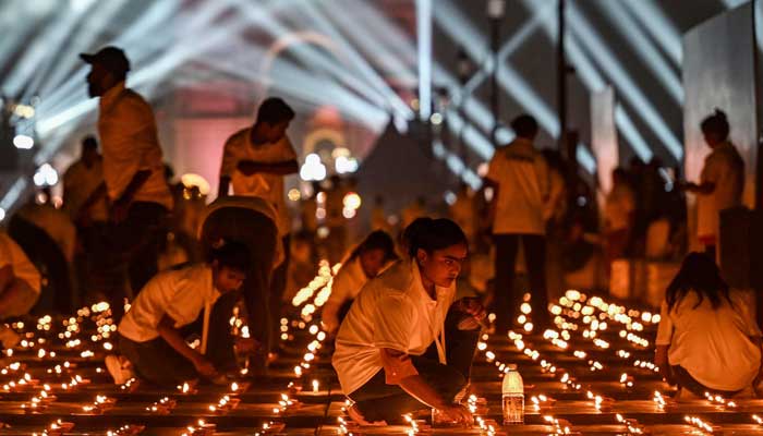 People light diyas at the India Gate memorial as part of the Diwali celebrations, the Hindu festival of lights, at Kartavya Path in New Delhi on October 18, 2025.  — AFP