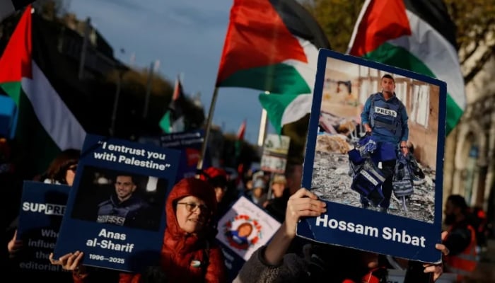 Demonstrators hold placards of slain journalists from Gaza Hossam Shbat and Anas al-Sharif, in support of Palestinians during a march on the International Day of Solidarity, in Dublin, Ireland. — Reuters