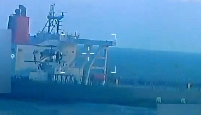 A US military helicopter flies near an oil tanker during a raid described by US Attorney General Pam Bondi as its seizure by the United States off the coast of Venezuela, December 10, 2025, in a still image from video. — Reuters