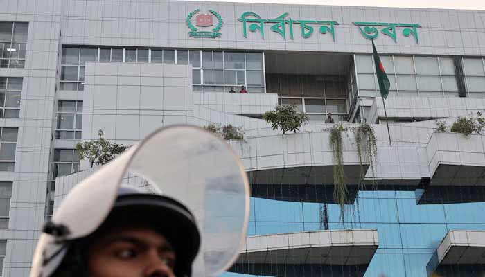 A police officer stands guard in front of the Bangladesh Election Commission office ahead of the expected general election schedule announcement, in Dhaka, Bangladesh, December 11, 2025.— Reuters