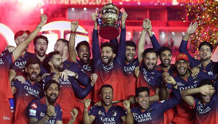 Royal Challengers Bengalurus Rajat Patidar lifts the trophy as he celebrates with teammates after winning the Indian Premier League. — Reuters