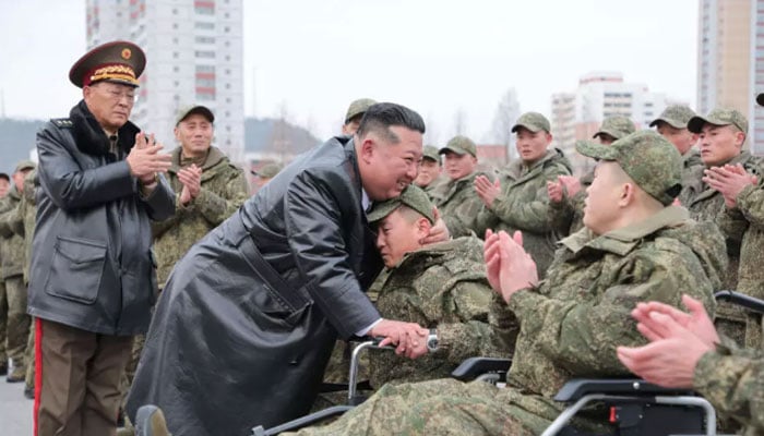 A picture released from North Koreas official Korean Central News Agency (KCNA) showing North Korean leader Kim Jong Un welcoming soldiers in this undated image. — AFP