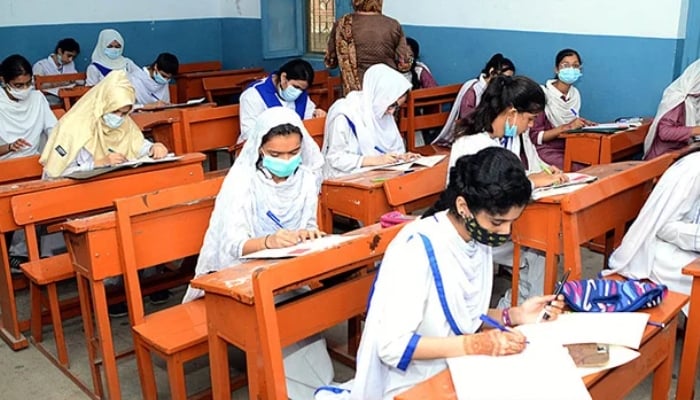 Students solving question papers during the annual examination of HSC (Part-II) at Hayat Girl’s High School in Hyderabad. — APP/File