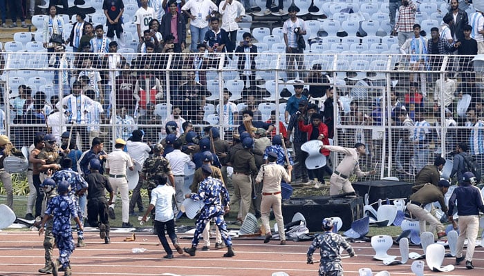 Police and security clash with fans after Argentine soccer star Lionel Messi left Vivekananda Yuva Bharati Krirangan in Kolkata, India, on December 13, 2025. — Reuters