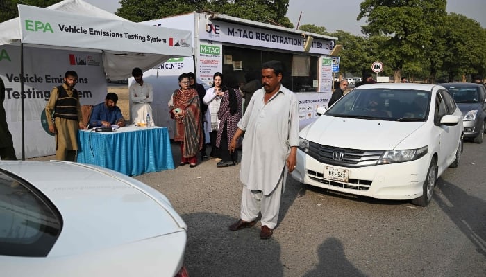 This picture taken on December 10, 2025, shows residents registering their cars at an emission testing point in Islamabad. — AFP