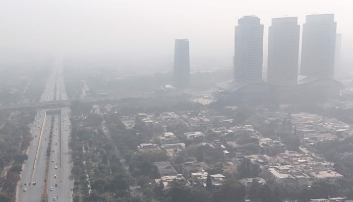 An aerial photograph shows buildings engulfed in dense smog in Islamabad on December 4, 2025. — AFP