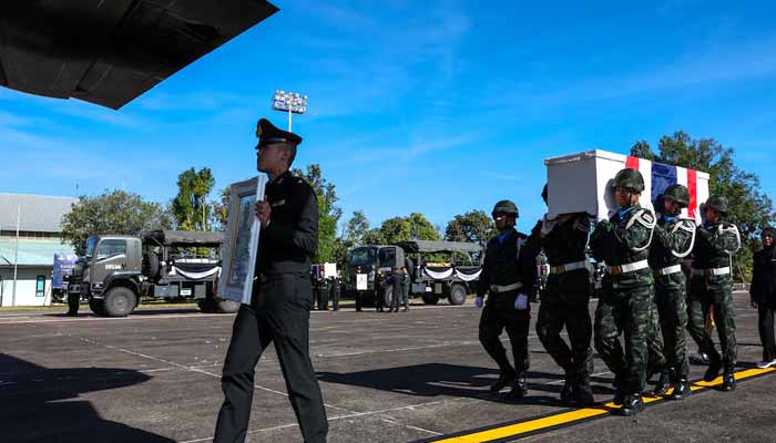 Military personnel carry the coffin of Private Mustageem Chema, covered by the Thai national flag, during a procession ceremony to transport bodies to their home town, at a military airport amid deadly clashes between Thailand and Cambodia along a disputed border area, in Ubon Ratchathani province, Thailand, December 14, 2025. — Reuters