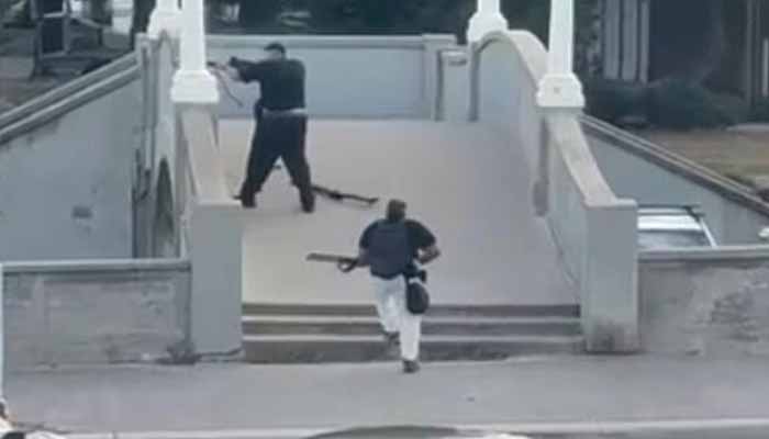 The gunmen pictured firing shots at Bondi Beach in Sydney on December 14, 2025. — Screengrab via X