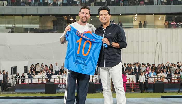 Former Indian cricketer Sachin Tendulkar (right) gifts his signatured T-shirt to Argentina’s footballer Lionel Messi during his Goat Tour at Wankhede Stadium in Mumbai on December 14, 2025. — X/@ sachin_rt
