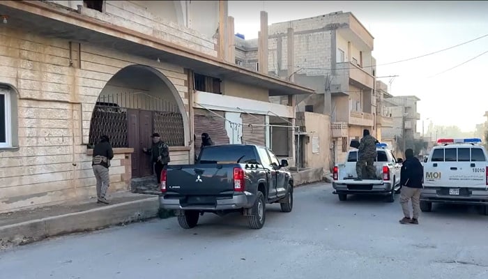 Troops outside the house of suspects linked to the shooting of US and Syrian troops in the central Syrian town of Palmyra. — Screenshot via Reuters