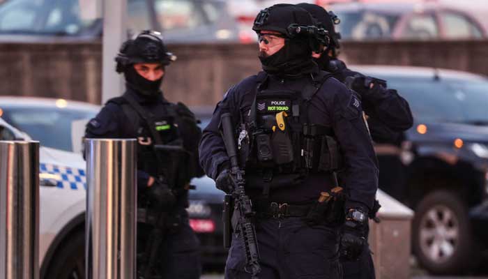 Armed police work at the scene after a shooting incident at Bondi Beach in Sydney on December 14, 2025. — AFP