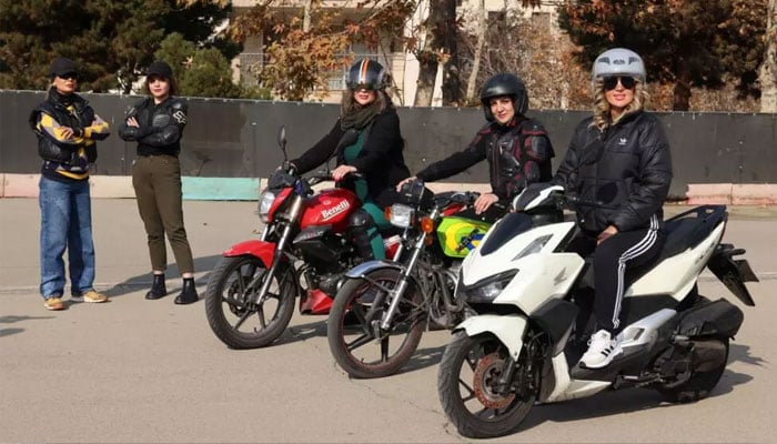 Iranian women bikers pose for a picture during their training. — AFP