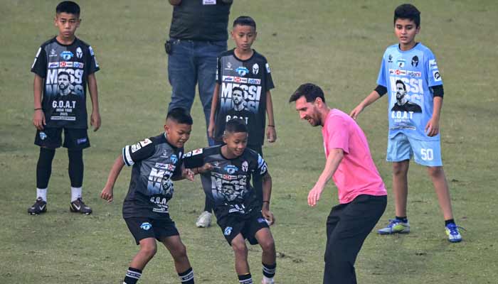 Argentina’s footballer Lionel Messi (2right) plays football with children during his Goat Tour at the Arun Jaitley Stadium in New Delhi on December 15, 2025. — AFP