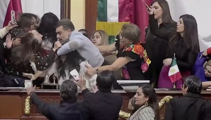Screengrab shows brawl between government and opposition lawmakers in the Congress of Mexico City, Mexico, Decemebr 15, 2025. — X/@kikemireles