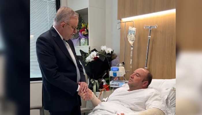 Australia´s PM Anthony Albanese meets meeting Ahmed al Ahmed, the man who disarmed one of the attackers during the Bondi beach attack, in hospital in Sydney on December 16, 2025. — X@AlboMP