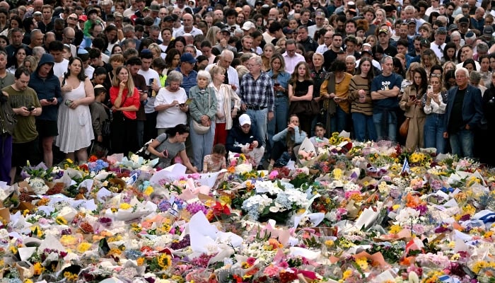 Mourners gather at a tribute at the Bondi Pavilion in memory of the victims of a shooting at Bondi Beach, in Sydney, on December 16, 2025. — AFP