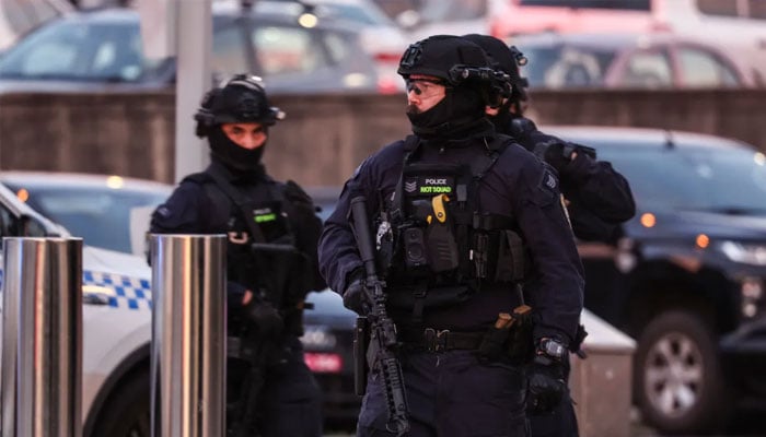 Armed police at the scene of the shooting. — AFP