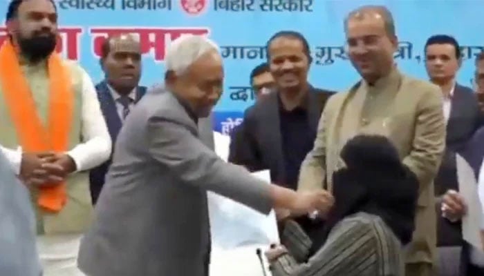 Bihar Chief Minister Nitish Kumar removes hijab of a newly recruited doctor during an official event on December 15, 2025. — X/ @SouthAsiaIndex/screengrab