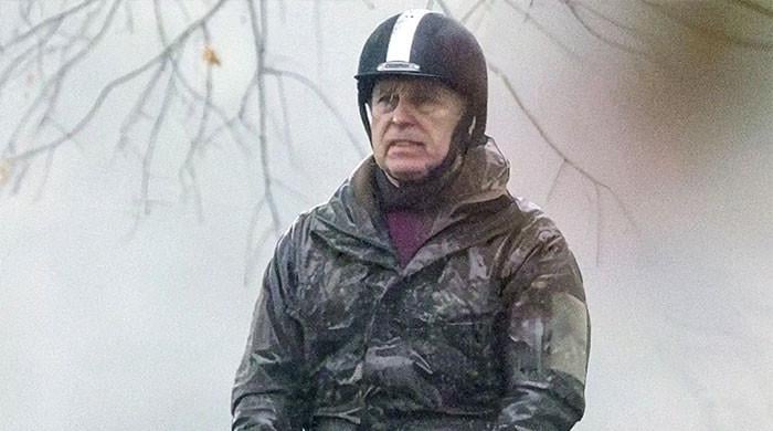 Andrew Mountbatten-Windsor takes soggy solo ride while daughters dine at Palace