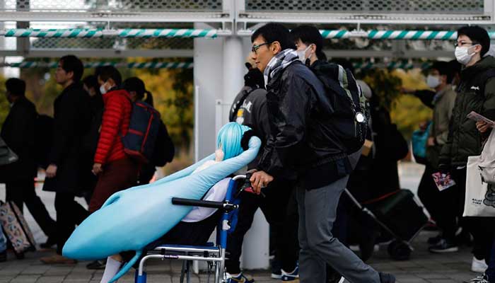 Akihiko Kondo carries life-sized doll of character Hatsune Miku in Tokyo, Japan. — Reuters