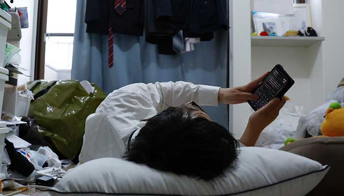 A 41-year-old Japanese man who held a ceremonial wedding with two-dimensional character Kimera Toyooka uses an AI app to chat with character at his home in Tokyo, Japan. — Reuters