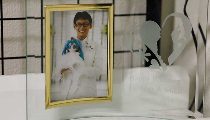 A framed wedding photo of Akihiko Kondo who married persona of Hatsune Miku, a virtual pop idol. — Reuters
