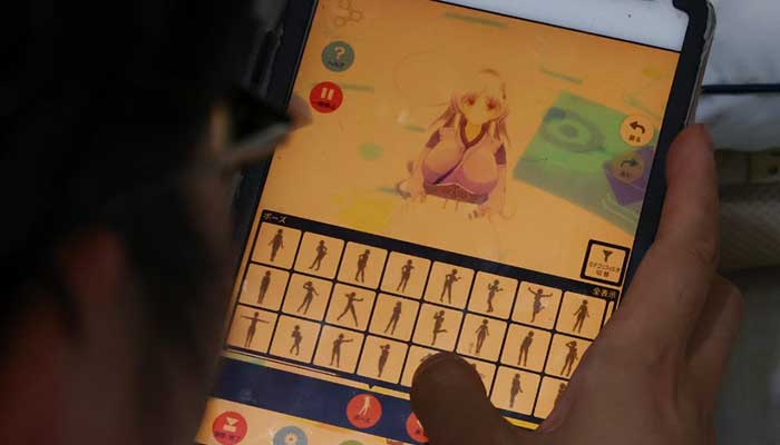 A 41-year-old Japanese man who held a ceremonial wedding with two-dimensional character Kimera Toyooka uses a tablet app to generate an image of character at his home in Tokyo, Japan. — Reuters