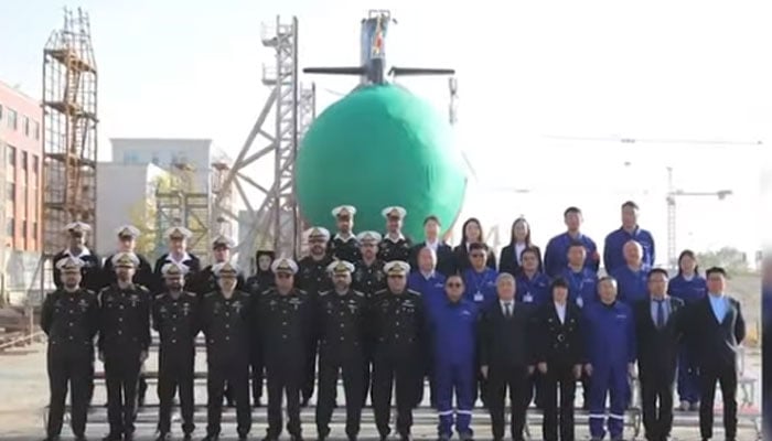 Pakistani and Chinese naval officials pose for a group photo at the the launch of the Pakistan Navy’s fourth Hango-class submarine, Ghazi, in Wuhan, China on December 17. — Facebook/screengrab/ISPR