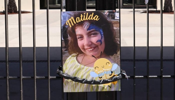 A poster of 10-year-old Matilda, who was killed in the December 14 Bondi Beach shooting attack, is hung on the gate of the Bondi Pavilion, in Sydney on December 18, 2025. — AFP