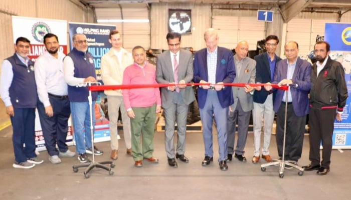 Ribbon cutting marks the official departure of the aid containers. — Reporter