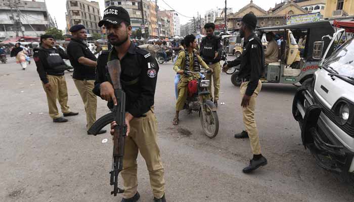 Police personnel in duty ahead of Ashura procession in Karachi. — INP