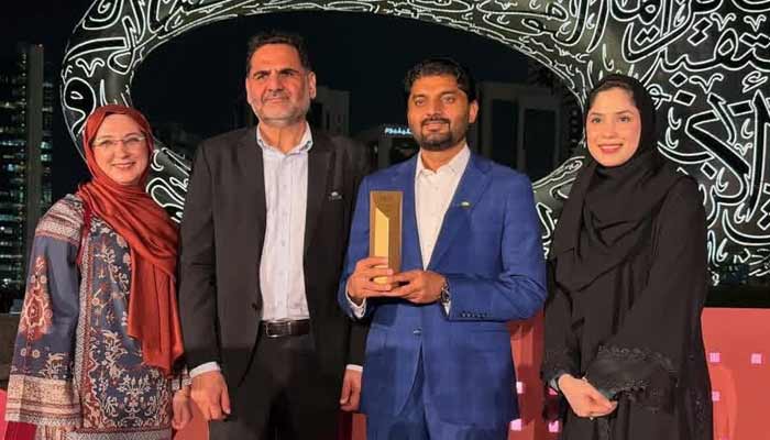 Representatives of the Pakistan Association Dubai (PAD) pose with the Gold Category Award at the ETHRAA Empowerment Programme ceremony in Dubai. — Reporter