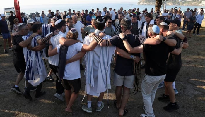 Members of the Jewish community gather for Shacharit, morning prayers, as the crime scene was reopened following the mass shooting at Bondi Beach on Sunday, in Sydney, Australia, December 19, 2025. — Reuters