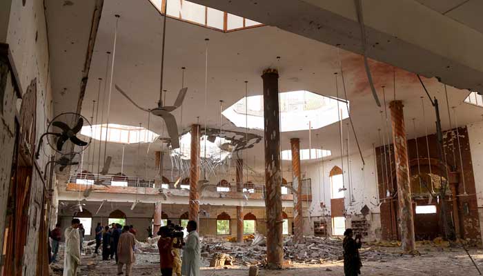 Members of the media film the inside of a building after it was hit by an Indian strike in Bahawalpur, on May 7, 2025. — Reuters