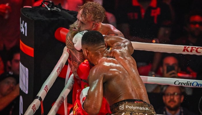 US boxer and influencer Jake Paul (L) and British boxer Anthony Joshua fight in a non-title heavyweight bout at the Kaseya Centre in Miami, Florida, US, on December 19, 2025. — AFP
