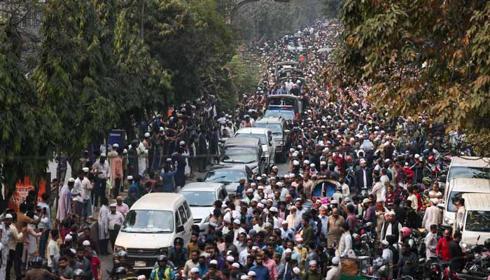 Bangladeshis rally along a vehicle carrying the body of youth leader Sharif Osman Hadi, as the deceased is taken for burial in Dhaka on December 20, 2025.— AFP